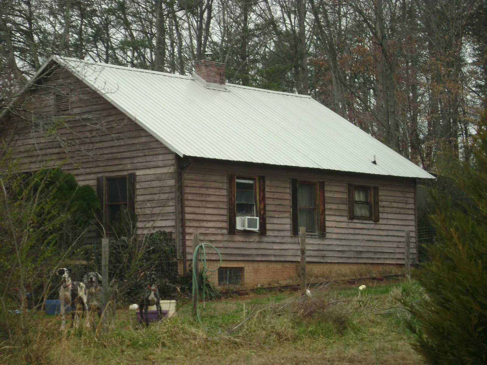 White metal roof on an old wood sided farmhouse, from a Metal Roof Installation job in Carlisle